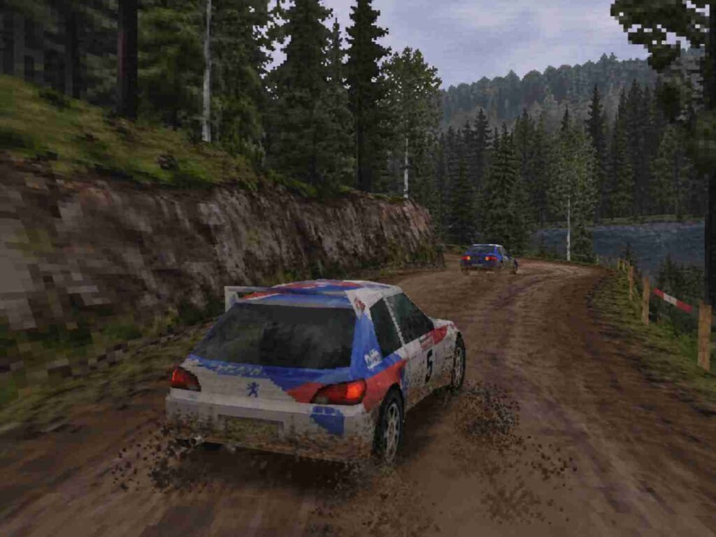 V-Rally 2 rally car racing through a muddy forest stage